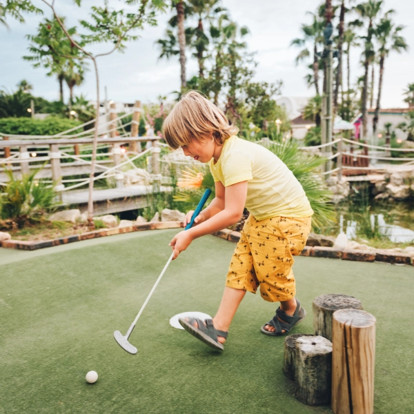 Little Boy Playing Mini Golf 600X600