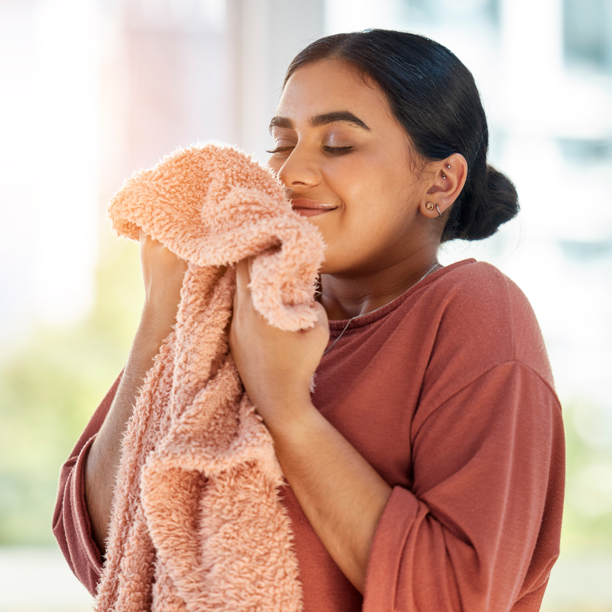 Woman Smelling Fresh Clean Orange Towel